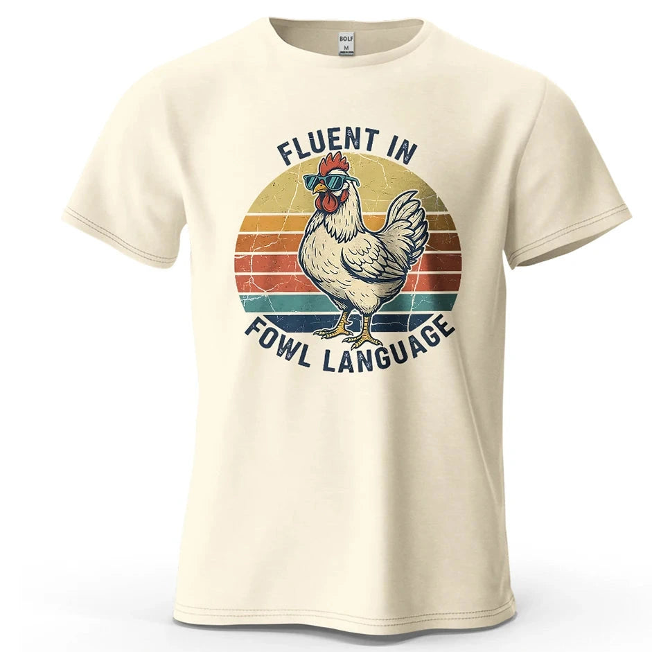 Beige t-shirt with a rooster graphic and text 'Fluent in Fowl Language' on a white background